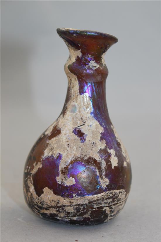 A Roman amber glass flask, c.2nd century AD, 11cm